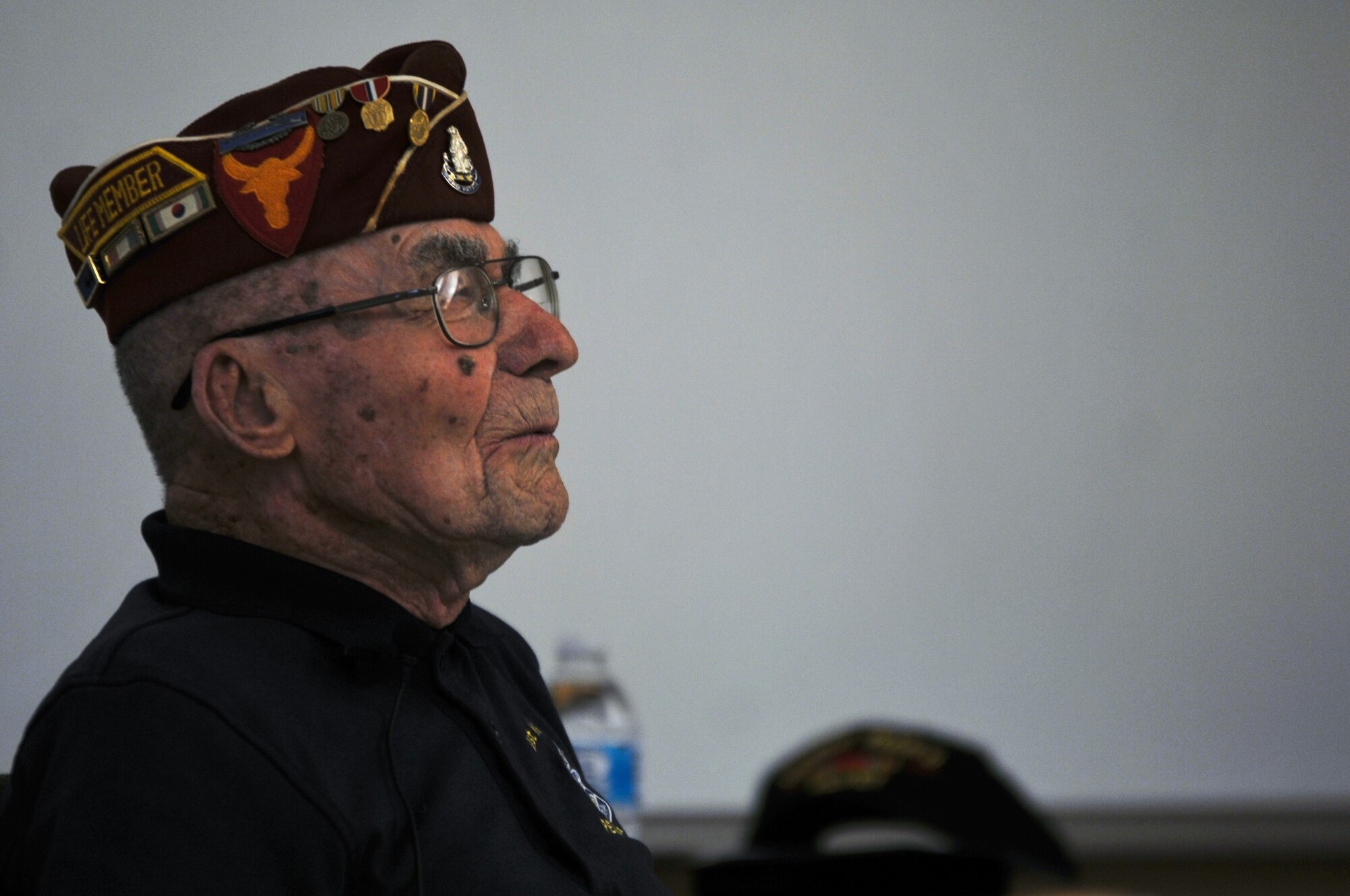 Paul Kerchum, a retired chief master sergeant with the Air Force and the Army Air Corps, recalls a moment while describing his experiences in World War II and his survival of the Bataan Death March at White Sands Missile Range, N.M., March 24, 2018. Kerchum addressed a crowd who gathered to hear his and six other survivors’ experiences with the Bataan Death March, and to support the 2018 Bataan Memorial Death March, a 26.2-mile race which honors those who defended the Philippines during World War II. (U.S. Army photo by Pvt. Matthew J. Marcellus)