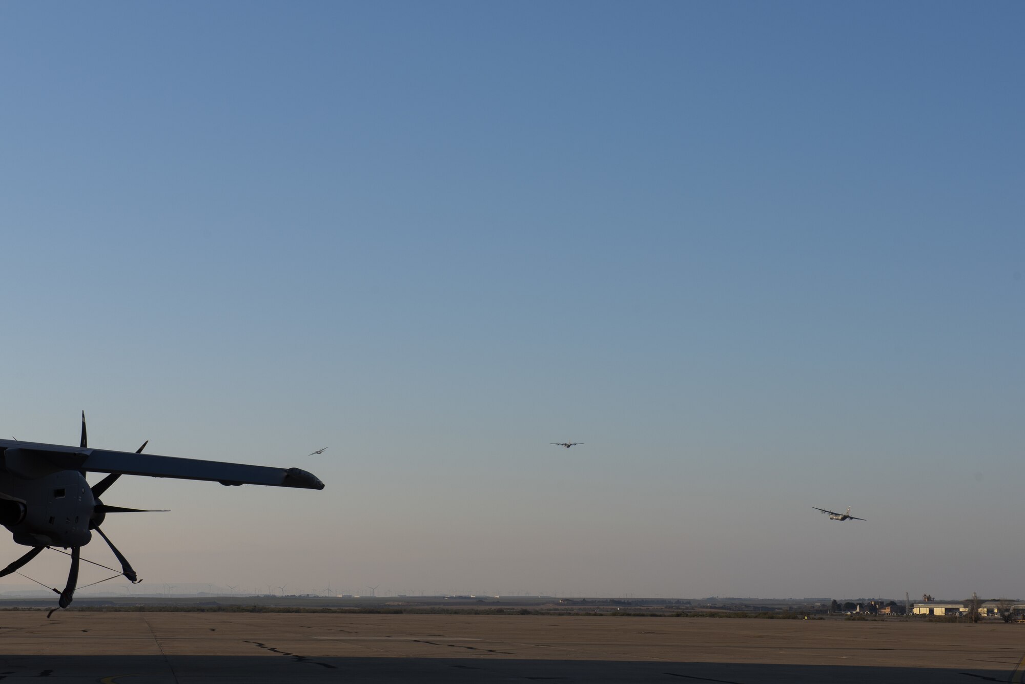Three aircraft are in the blue sky