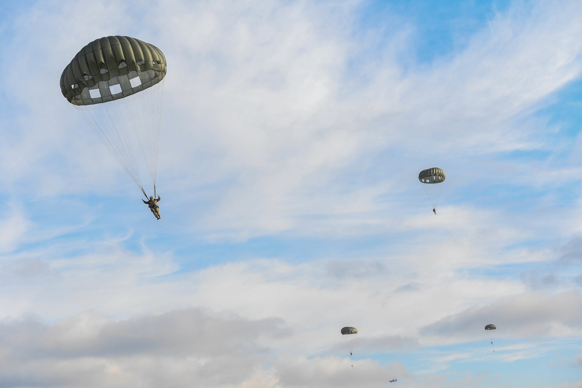 U.S. Army paratroopers from the 173rd Airborne Brigade and 1st Battalion, 10th Special Forces Group descend into Alzey Drop Zone in Ober-Flörsheim, Germany, Jan. 20, 2023.