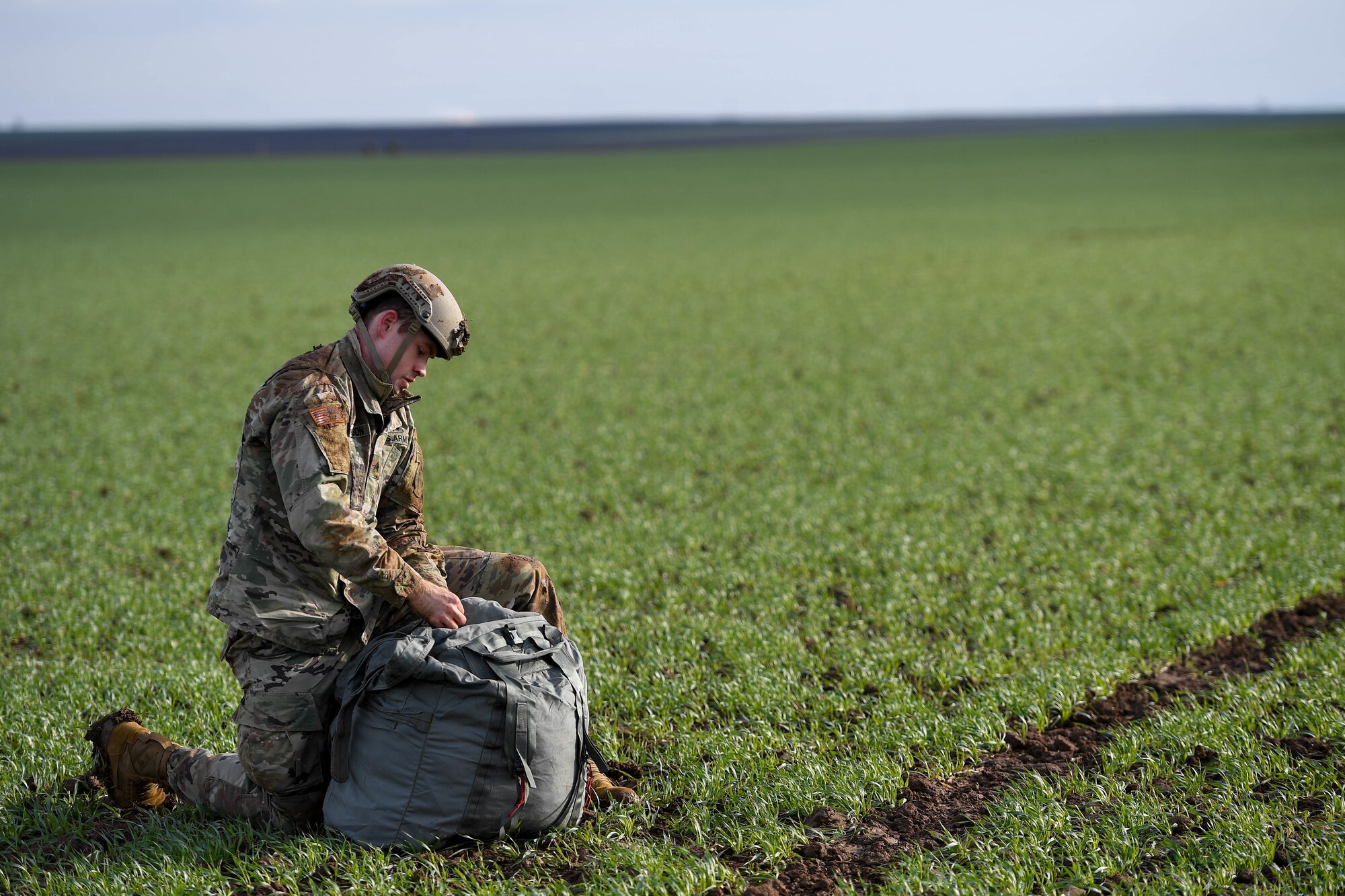 U.S. Army Sgt. Austin Nicholson, 1st Battalion, 10th Special Forces Group, collects his parachute after his jump into Alzey Drop Zone in Ober-Flörsheim, Germany, Jan. 20, 2023.