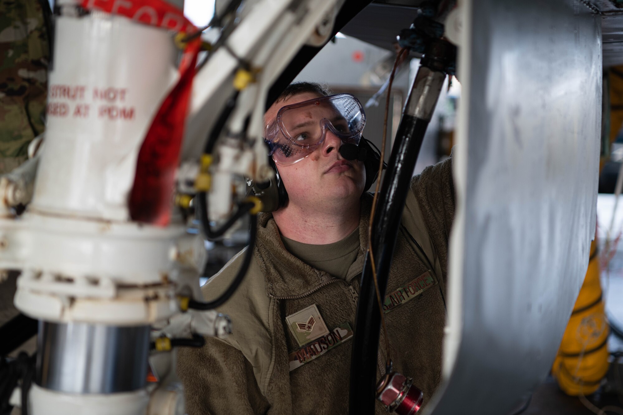 An Airman conducts aircraft maintenance.