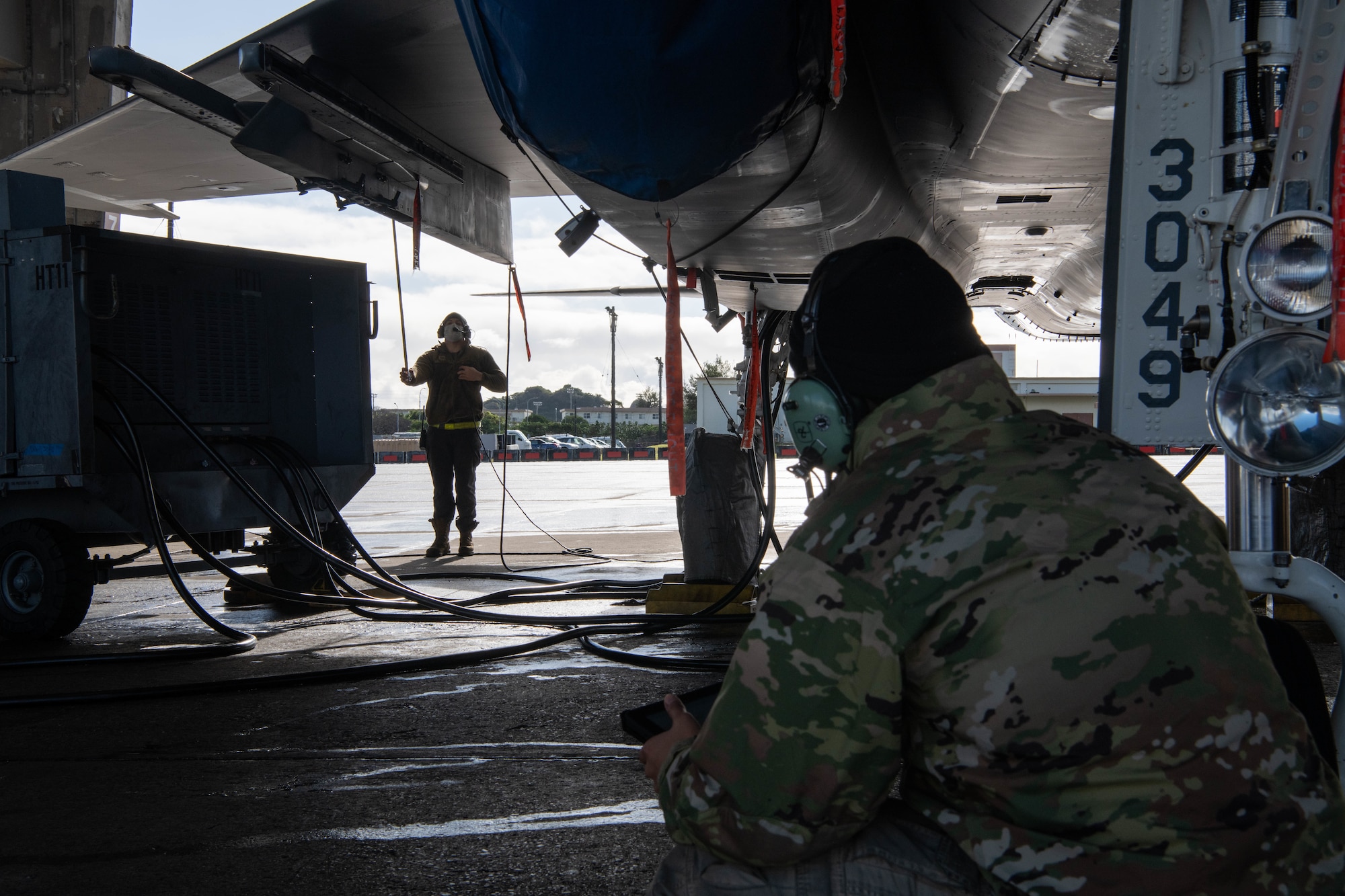 Airmen perform maintenance on an aircraft.