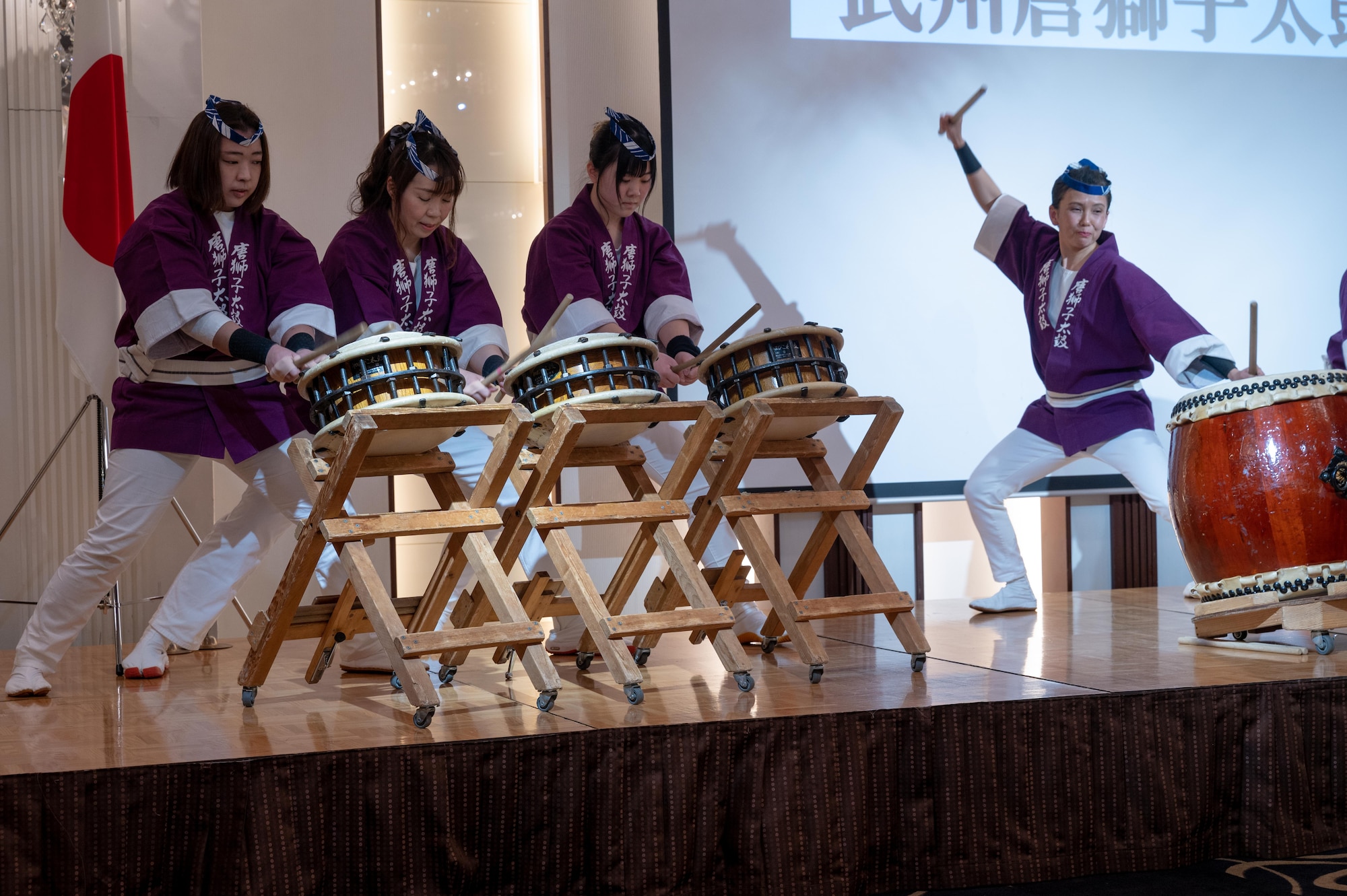 A drum band performs on stage.