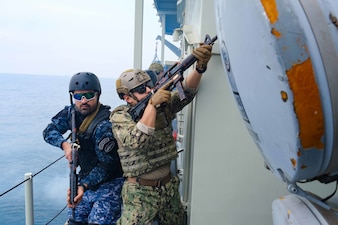 Sailors assigned to CTF-152 rehearse vessel boarding and search procedures in the Arabian Gulf aboard a Royal Bahrain Naval Force ship.