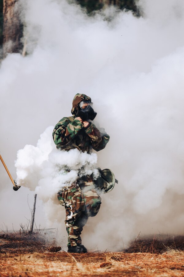 A U.S. Marine with Division Training Company 2d Marine Division, gets ambushed while conducting the Monitoring and Decontamination Chemical, Biological, Radiological, Nuclear Pilot Course on Camp Lejeune, North Carolina, Jan. 19, 2023. The course was developed by DTC to train CBRN response teams within 2d MARDIV battalions. (U.S. Marine Corps photo by Lance Cpl. Isabella R. Mancini)