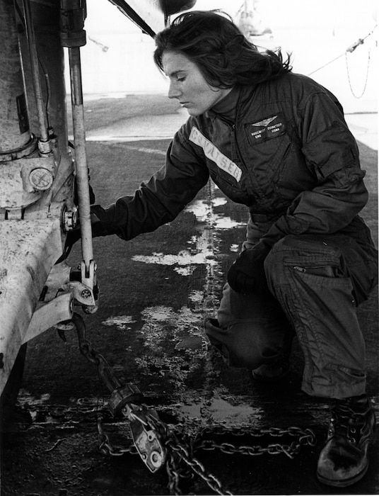 VIRGINIA BEACH, Va. (Jan. 9, 1975) Ensign Rosemary Conaster (later Mariner), assigned to Fleet Composite Squadron (VC) 2, makes pre-flight checks of the main gear of a Grumman S-2 Tracker antisubmarine aircraft at Naval Air Station Oceana in Virginia Beach, Virginia, Jan. 9, 1975.