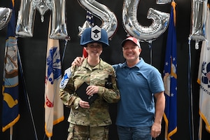 U.S. Air Force Senior Master Sgt. Heather Celano, 313th Training Squadron senior enlisted leader, celebrates news of her promotion with her spouse, retired U.S. Navy Senior Chief Master Diver Anthony Schudel, during the Chief Master Sgt. release party, at the Powell Event Center, Goodfellow Air Force Base, Texas, January 5, 2023. Celano was one of two who were promoted to Chief from the 17th TRW (U.S. Air Force photo by Senior Airman Ethan Sherwood.)