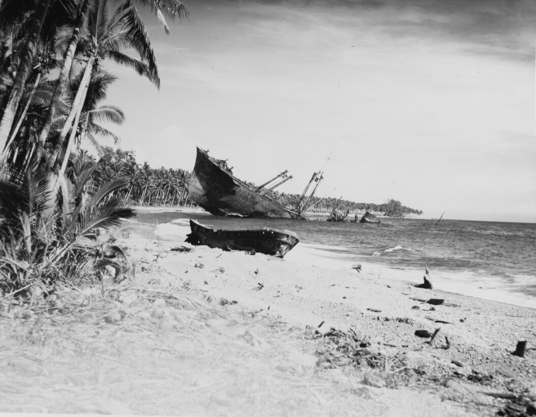 Japanese cargo ship Kyushu Maru beached and sunk on Guadalcanal in November 1942. She had been the victim of U.S. air attacks on 15 October 1942. Note wrecked Japanese landing craft in center. (80-G-K-1467-C)