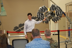 Arlen Biersgreen, program manager for Navigation Technology Satellite-3, or NTS-3, uses a 1:3 scale model to describe the spacecraft and details of the one-year experimental mission during the 2022 Media Day June 23, 2022, at Kirtland Air Force Base, New Mexico. The event took place at the Air Force Research Laboratory, or AFRL, Space Vehicles Directorate and Directed Energy Directorate with AFRL leadership and guests in attendance. (U.S. Air Force photo / Andrea Rael)