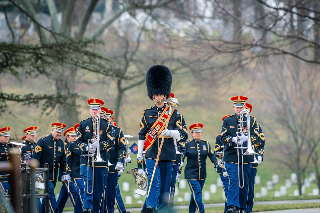 Soldiers dressed in ceremonial uniform attend an arrival ceremony.