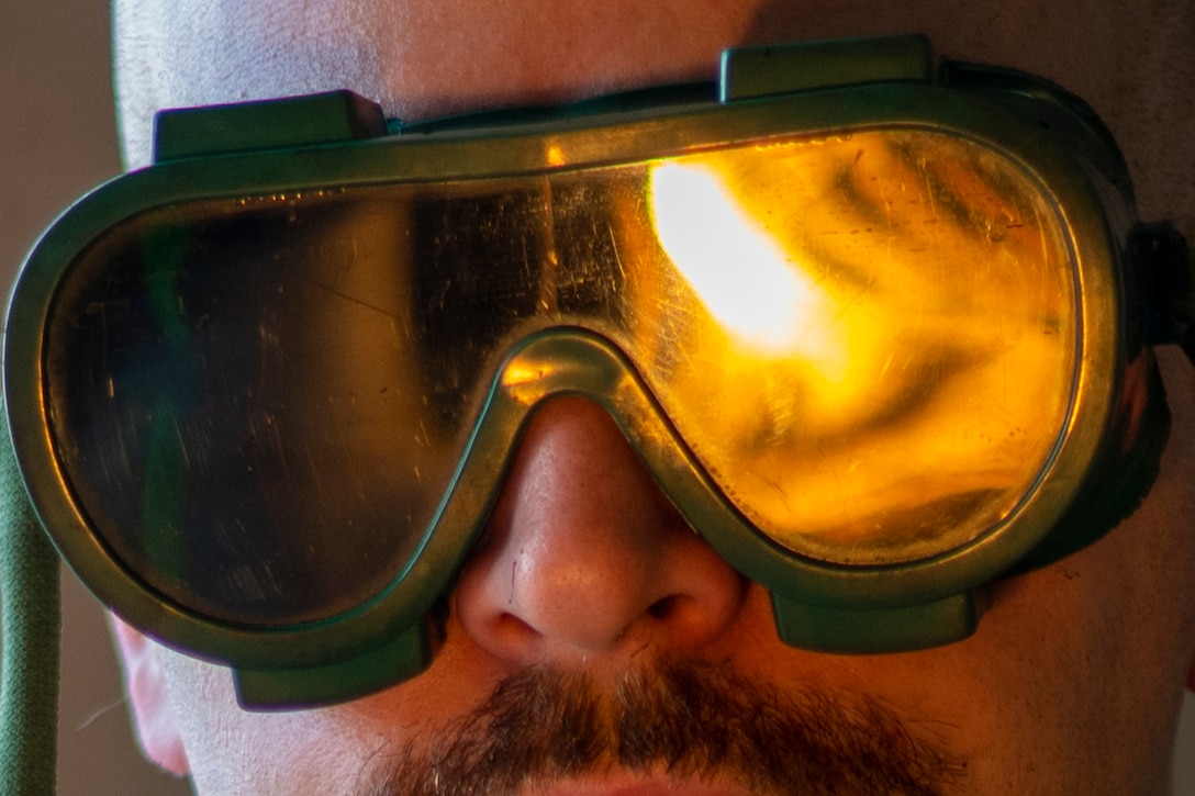 A close-up of an airman wearing protective goggles.