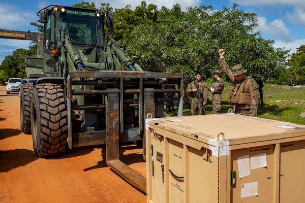 U.S. Marine Corps Cpl. Austin Merrill, a heavy equipment operator with Combat Logistics Battalion 13, 13th Marine Expeditionary Unit, directs a 624K tractor rubberized wheel articulated steering multipurpose during a Humanitarian Assistance and Disaster Relief exercise, Jan. 23 in Mullikulam.