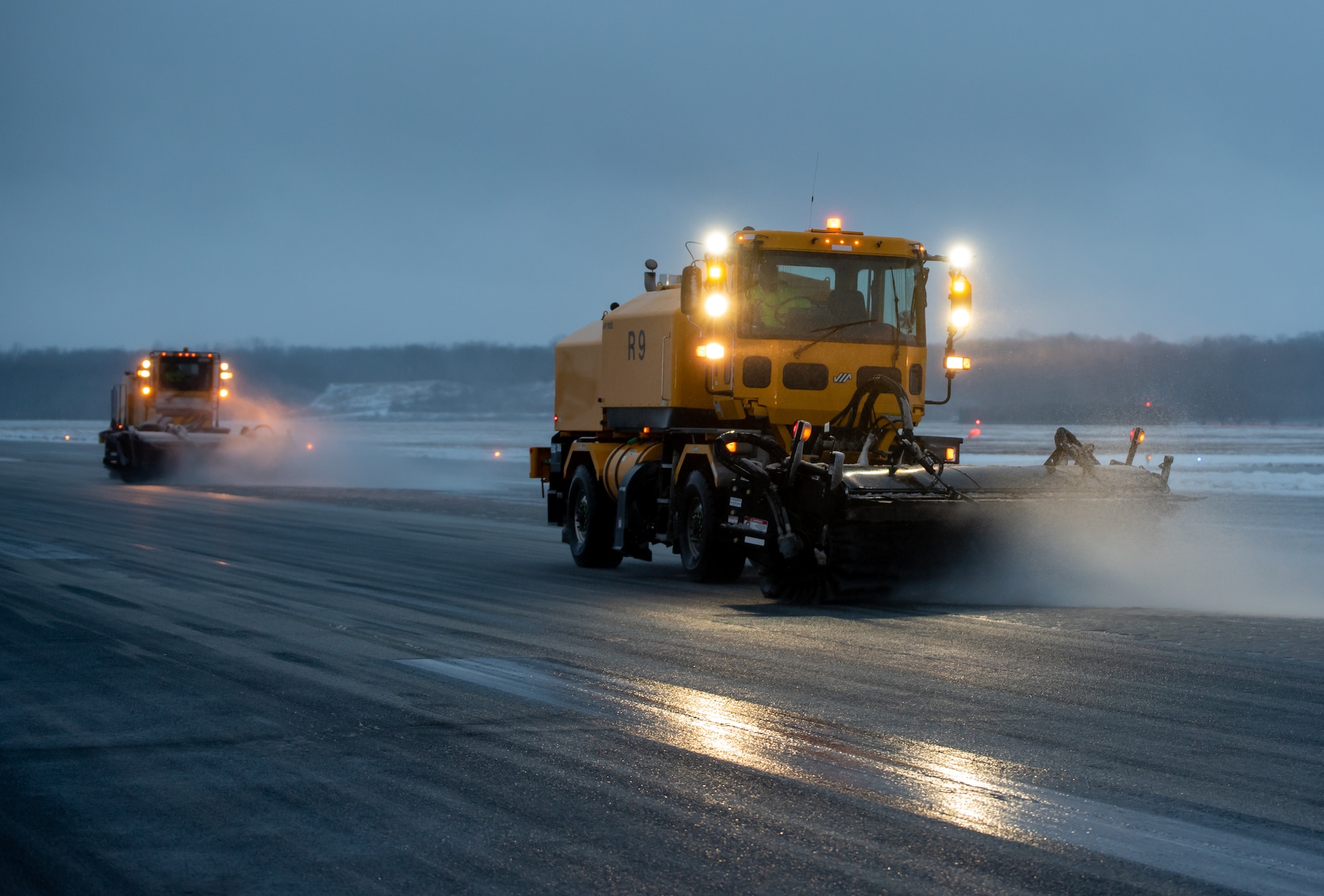A heavy-equipment operator from the 88th Civil Engineer Group’s snow-removal team uses a brush to clear the runway at Wright-Patterson Air Force Base, Ohio, Jan. 25, 2023. The team is responsible for clearing more than 18 million square feet of concrete to keep the airfield open. (U.S. Air Force photo by Matthew Clouse)