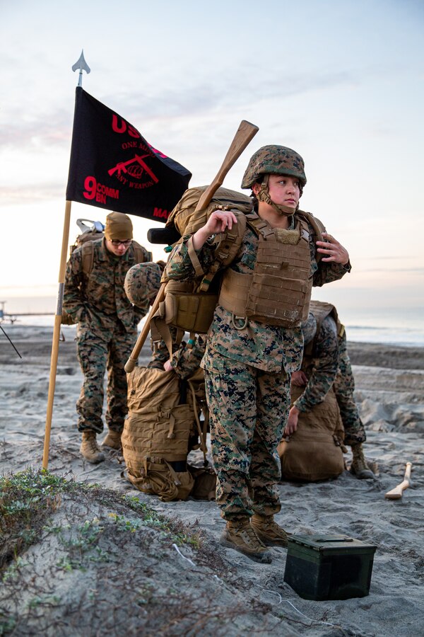 U.S. Marine Corps Cpl. Alexis Flippo, front, an imagery analysis specialist with 1st Intelligence Battalion, I Marine Expeditionary Force Information Group, dons her gear during a martial arts instructor course culminating event at Marine Corps Base Camp Pendleton, California, Dec. 15, 2022. MAI courses certify Marines to instruct and monitor Marine Corps Martial Arts Program training and advance Marines in the program, distinguishing their levels of experience with different colored belts. (U.S. Marine Corps photo by Lance Cpl. Gadiel Zaragoza)