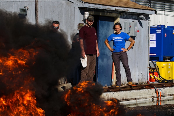 Kate Trubac, a Cold Regions Research and Engineering Laboratory research general engineer, oversees an in-situ burn experiment conducted with the Bureau of Safety and Environmental Enforcement. The burns are testing the efficiency of a new system designed to improve oil spill clean up.