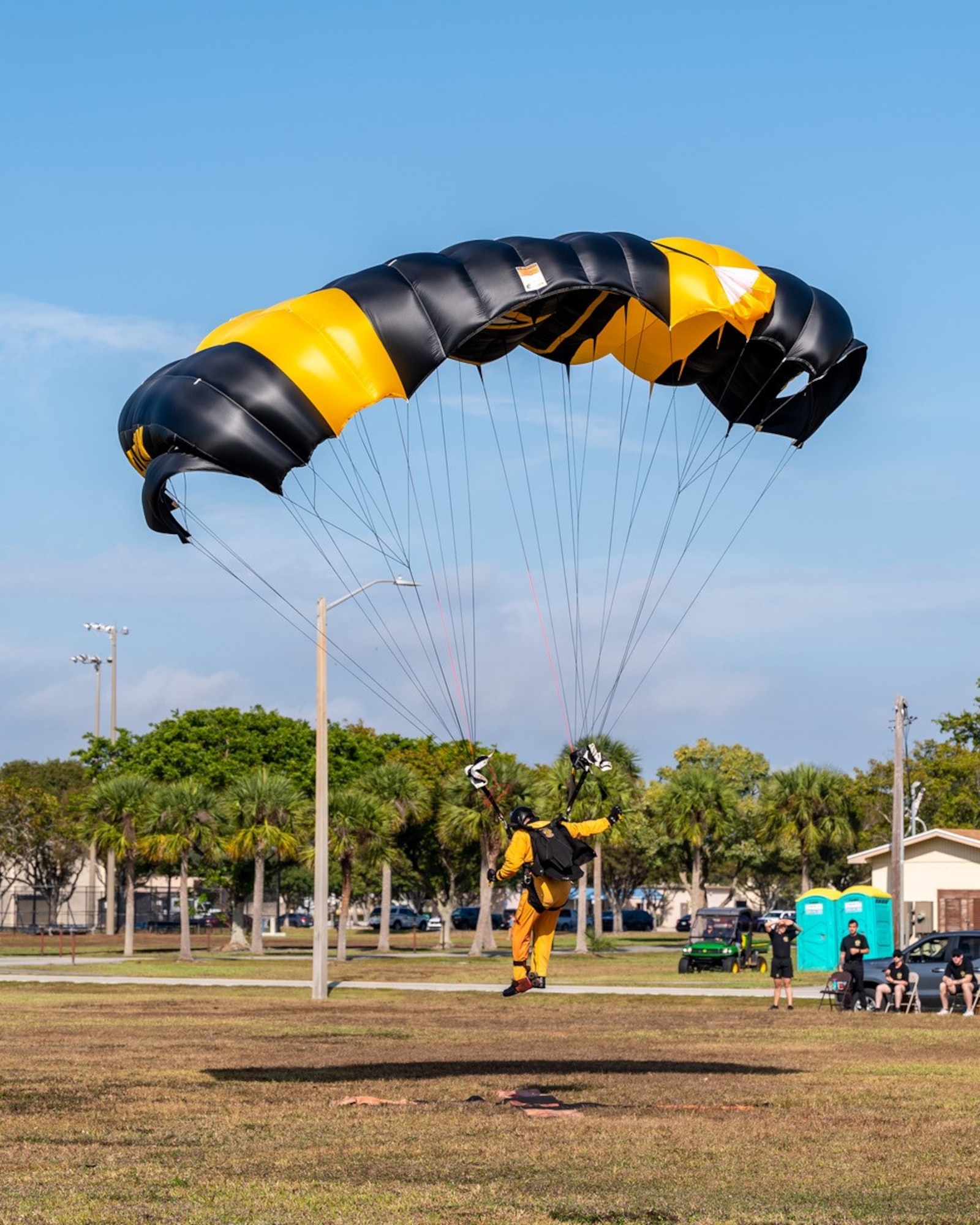 A member of the U.S. Army Parachute Team, The Golden Knights, prepare to land on the drop zone during Winter Training at Homestead Air Reserve Base, Fla., on Jan. 26, 2023. (U.S. Air Force photo by Tech. Sgt. Leo Castellano)