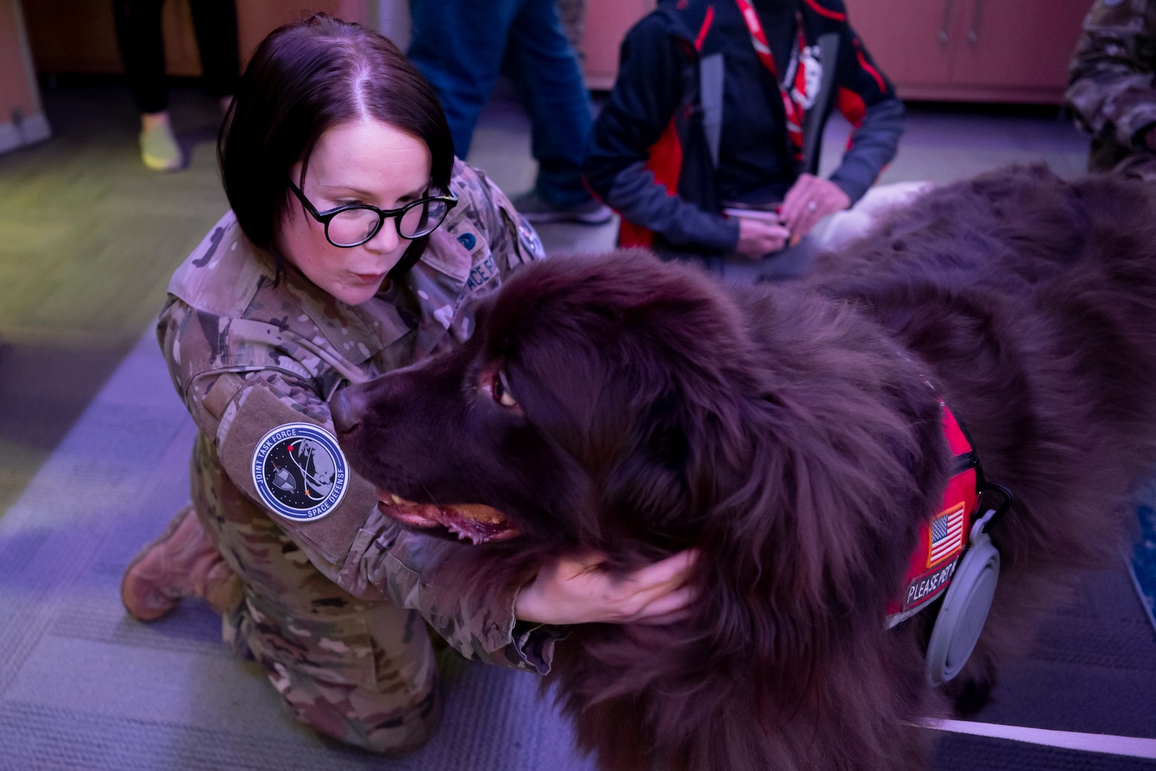 Woman in uniform pets dog