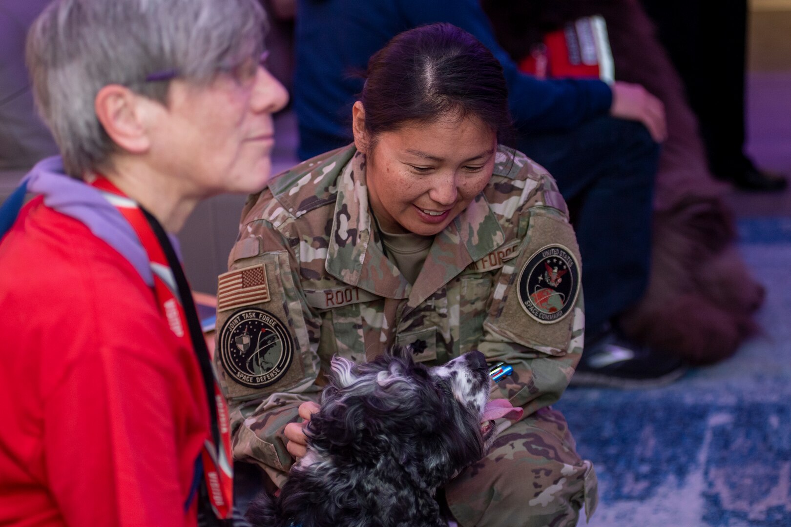 Woman in uniform pets dog