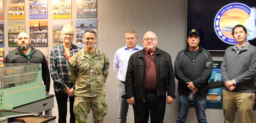 A group of individuals face the camera. They were part of a visit by DCMA personnel to the Navy facility in Groton, Conn.