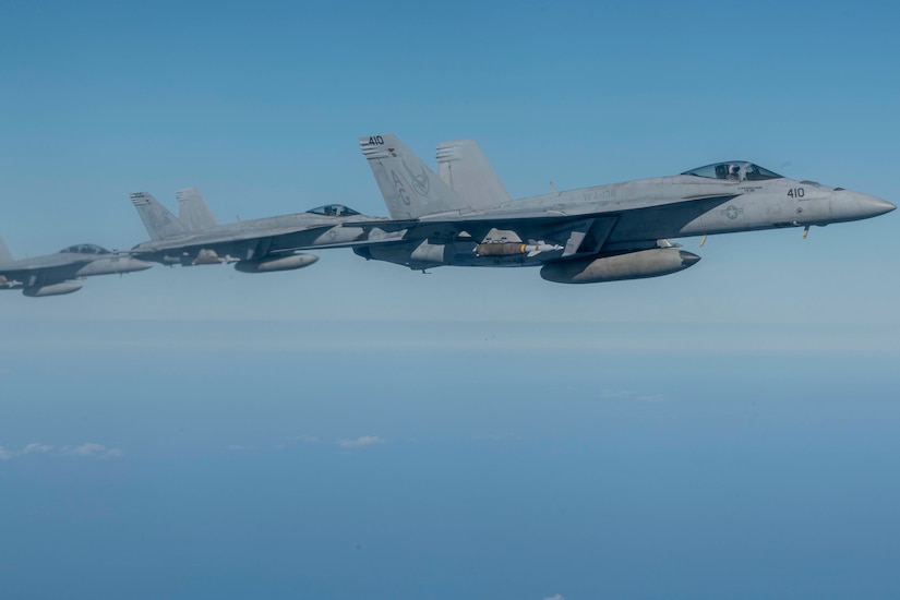 A group of aircraft fly in formation.