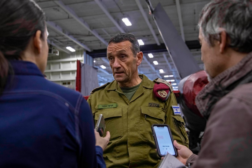 A general speaks to a group of reporters.