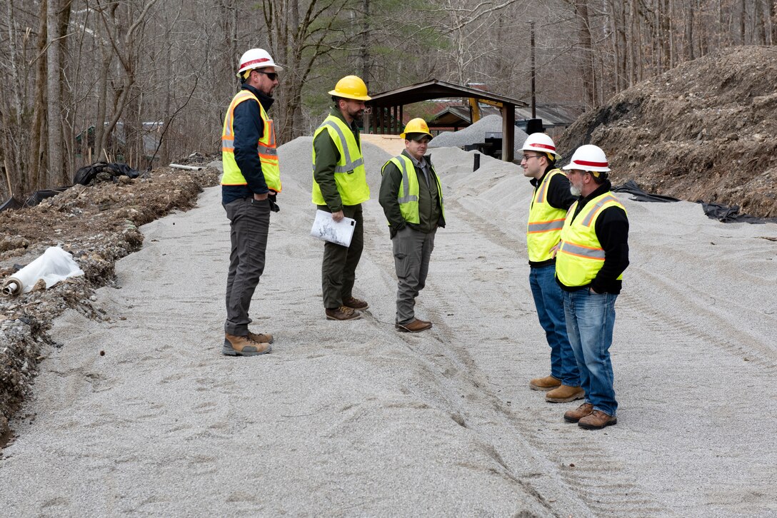 U.S. Army Corps of Engineers Nashville District and National Park Service officials review the progress of construction for a wastewater project underway Jan. 20, 2023, to provide a sanitary upgrade for the National Park Service Blue Heron Mine at the Big South Fork National River and Recreation Area in Stearns, Kentucky. (USACE Photo by Lee Roberts)