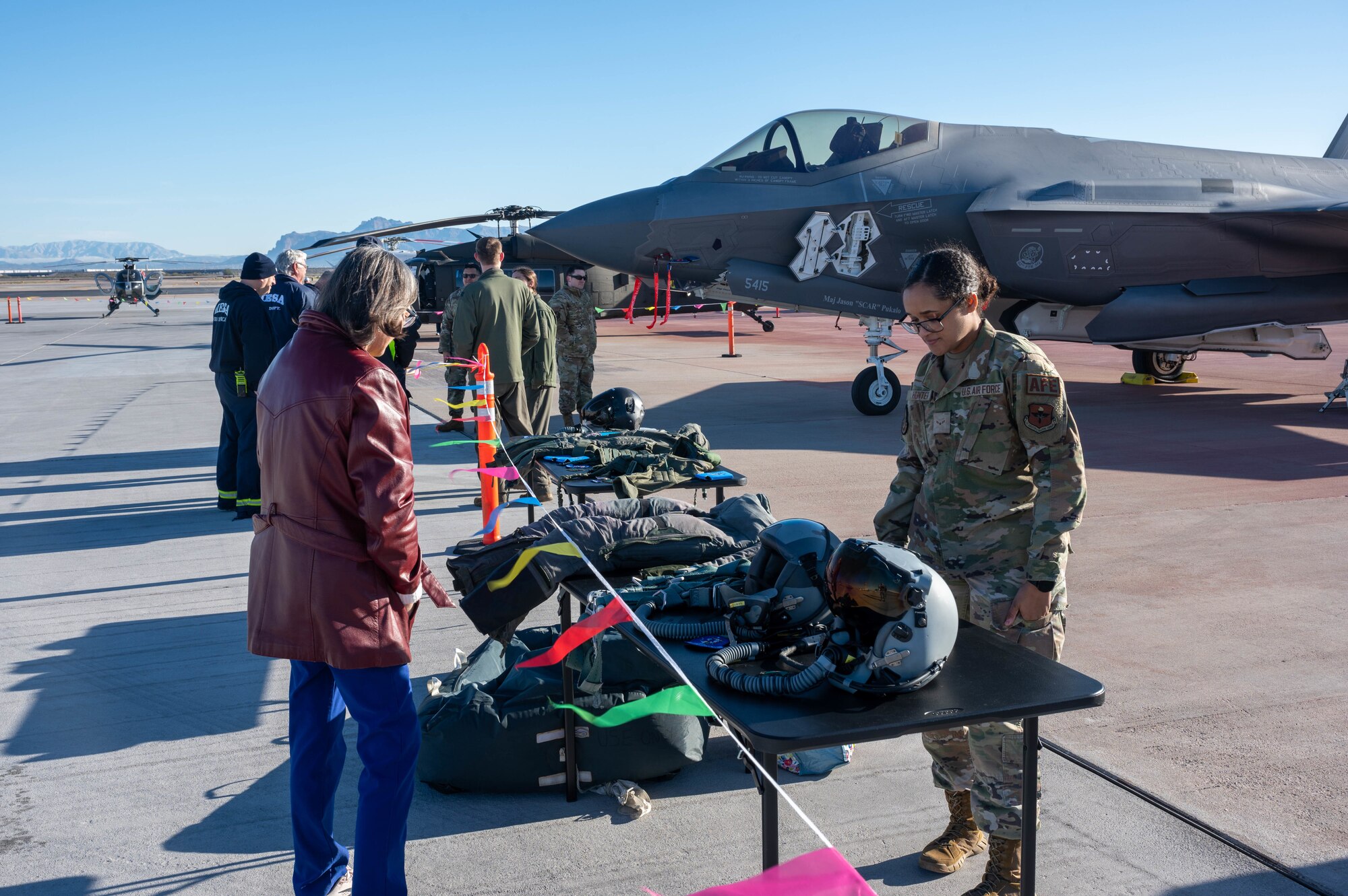 U.S. Air Force Airman 1st Class Alex Hunter, 56th Operational Support Squadron aircrew flight equipment technician, assigned to Luke Air Force Base, Arizona, showcases pilot flight equipment at the Mesa Gateway Aviation Day, Jan. 24, 2023, in Mesa, Arizona.