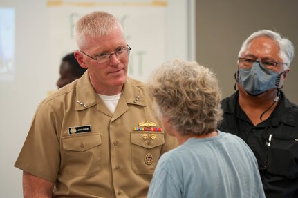 During an Environmental Protection Agency (EPA) hosted open house, U.S. Navy Vice Adm. John Wade, commander, Joint Task Force-Red Hill, listens to a community member at the Oahu Veterans Council and Center in Honolulu, Hawaii, Jan. 19, 2023.