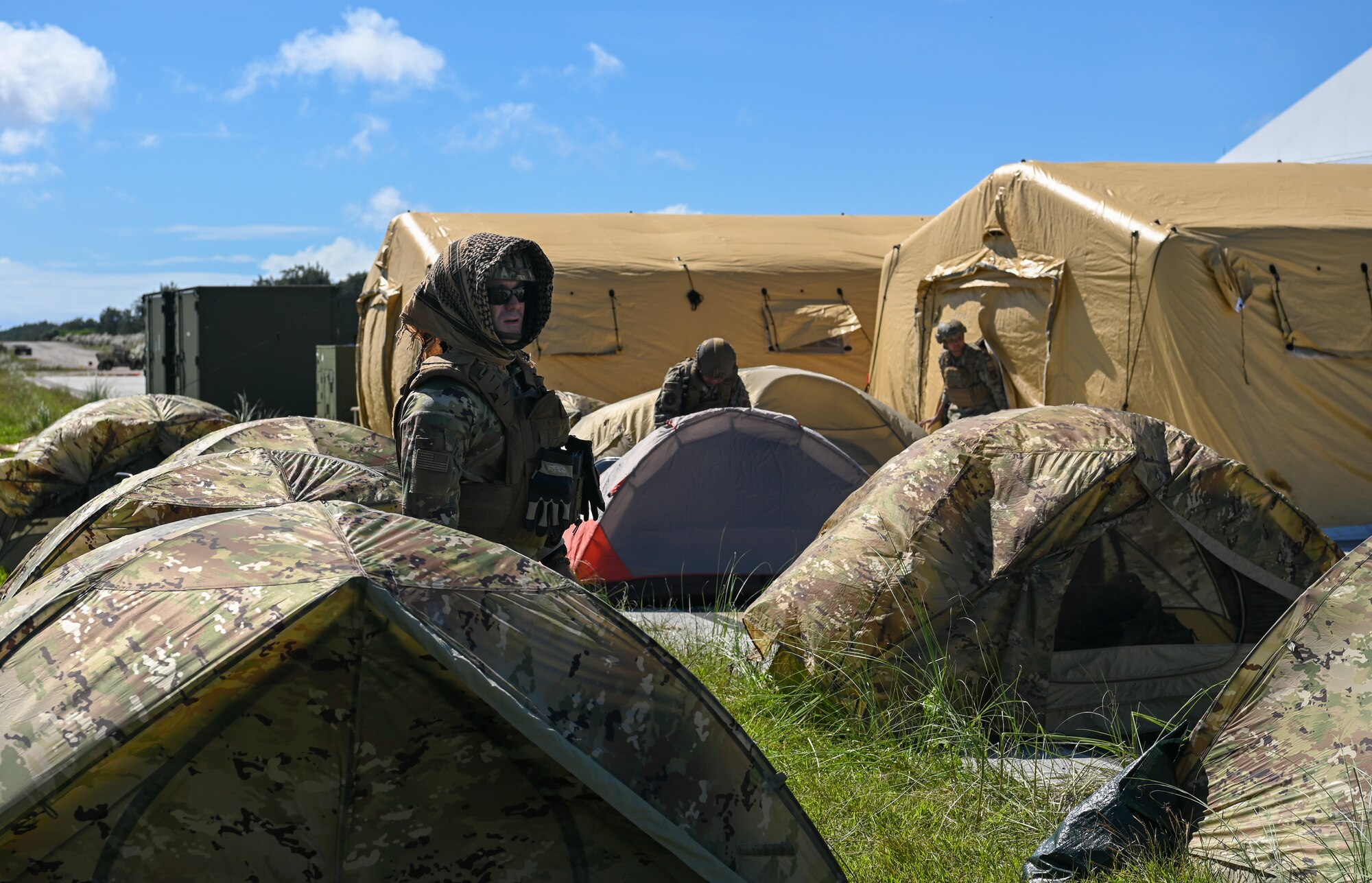 U.S. Air Force Airmen with the 736th Security Forces Squadron, take down tents onPacific Air Forces Regional Training Center-Andersen Air Force Base, Guam, Jan. 20, 2023. The 36th Contingency Response Group partnered with the 36th Airlift squadron from Yokota Air Base, Japan, to conduct a Field Training Exercise that tested operating in an austere environment.  The units conducted a variety training scenarios such as setting up airfield/aerial ports, accomplishing drop zone operations, establishing bed down and cargo yard, bare base build-ups, communication hub and spoke operations, and securing the airbase for operation in an expeditionary environment.(U.S. Air Force photo by Airman 1st Class Allison Martin)