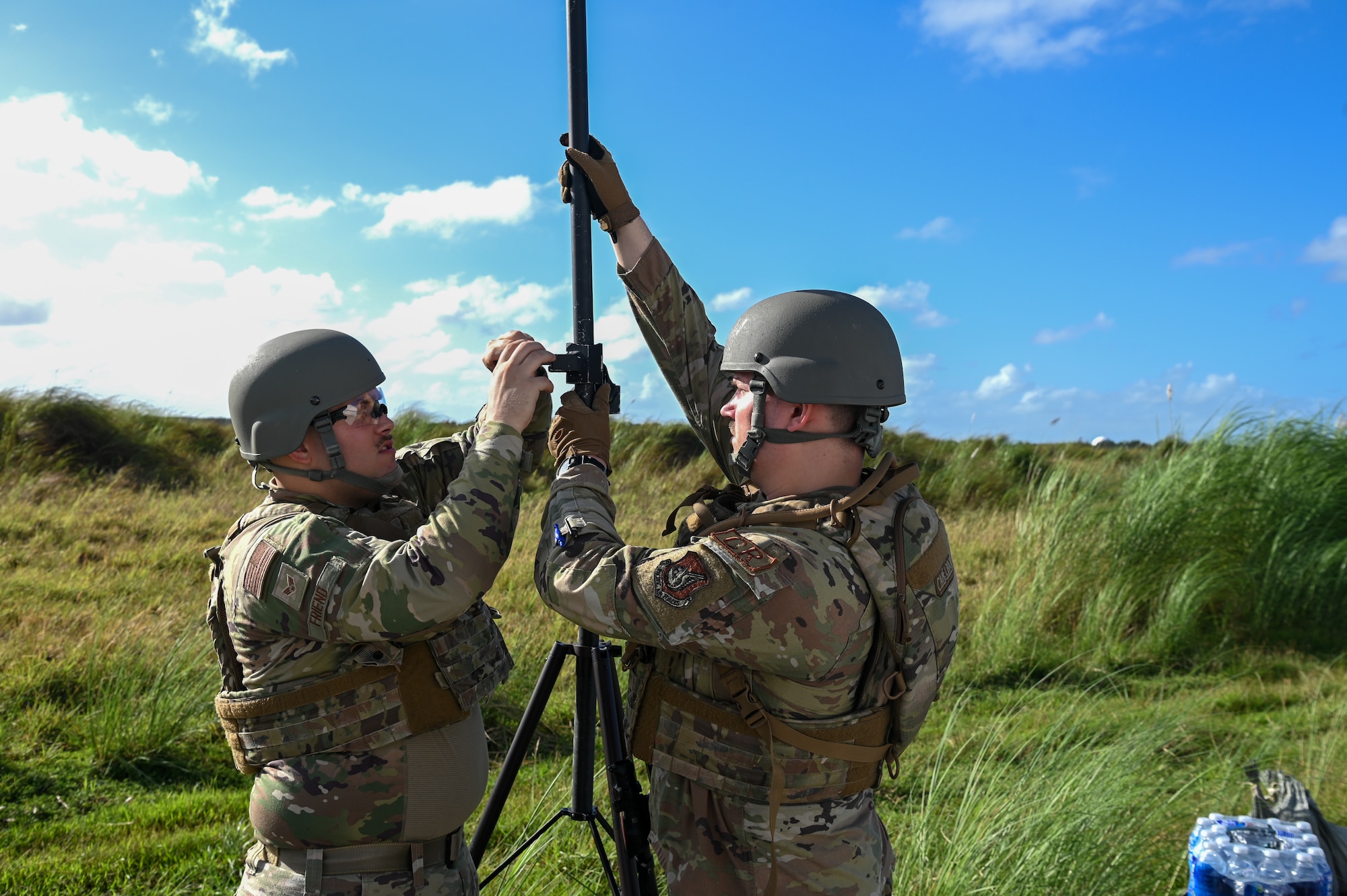U.S. Air Force Senior Airman Evan Freind, radio frequency technician and another Airman with the 644th Combat Communications Squadron, set up communication capabilities on Pacific Air Forces Regional Training Center-Andersen Air Force Base A, Guam, Jan. 19, 2023. The 36th Contingency Response Group partnered with the 36th Airlift squadron from Yokota Air Base, Japan, to conduct a Field Training Exercise that tested operating in an austere environment.  The units conducted a variety training scenarios such as setting up airfield/aerial ports, accomplishing drop zone operations, establishing bed down and cargo yard, bare base build-ups, communication hub and spoke operations, and securing the airbase for operation in an expeditionary environment.(U.S. Air Force photo by Airman 1st Class Allison Martin)