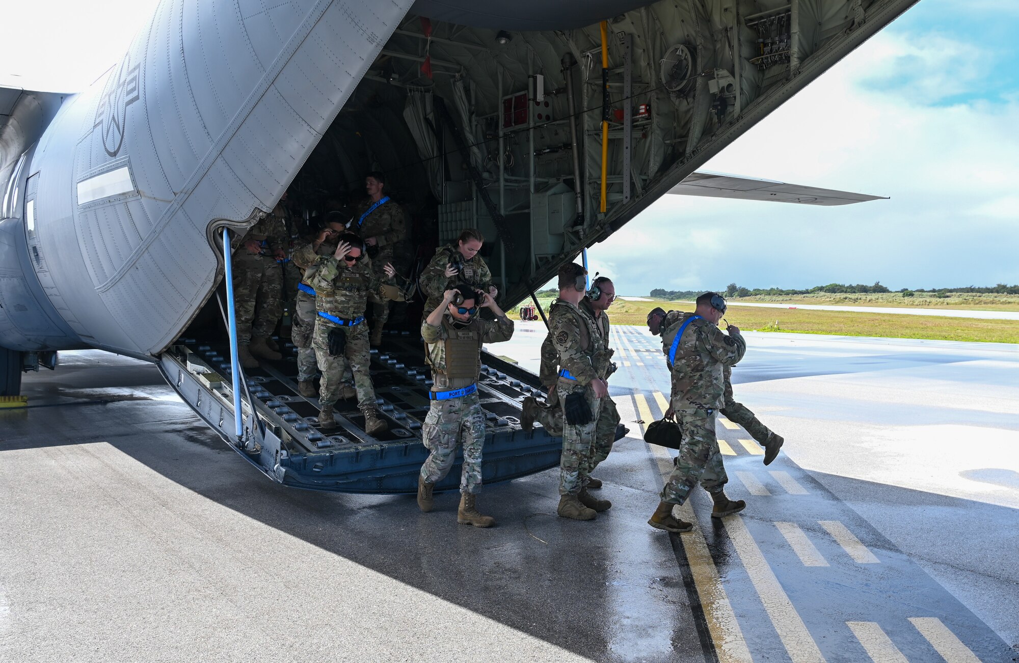 U.S. Air Force Airmen with the 734th Air Mobility Squadron walk out of a U.S. Air Force C-130J Super Hercules on Pacific Air Forces Regional Training Center-Andersen Air Force Base, Guam, Jan. 20, 2023. The 734th AMS split into small teams and performed rolling offloads of cargo during a Field Training Exercise. (U.S. Air Force photo by Airman 1st Class Allison Martin)