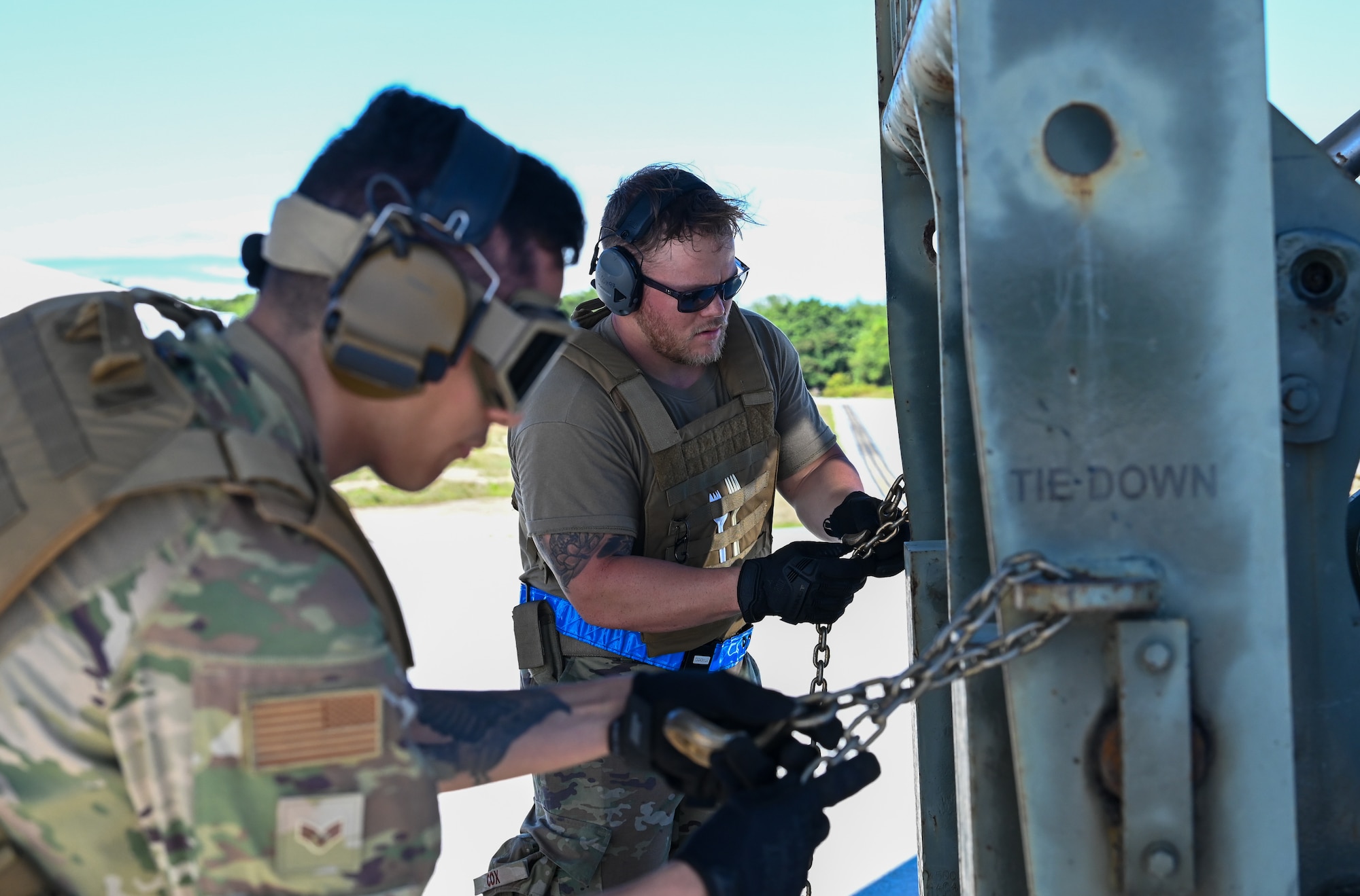 U.S. Air Force Senior Airman Edgar Arellano, an information controller and U.S. Air Force Staff Sgt. Gabriel Cox, a senior controller with the 734th Air Mobility Squadron, unload an U.S. Air Force C-130J Super Hercules on Pacific Air Forces Regional Training Center-Andersen Air Force Base, Guam, Jan. 20, 2023. The 734th AMS split into small teams and performed rolling offloads of cargo during a Field Training Exercise. (U.S. Air Force photo by Airman 1st Class Allison Martin)