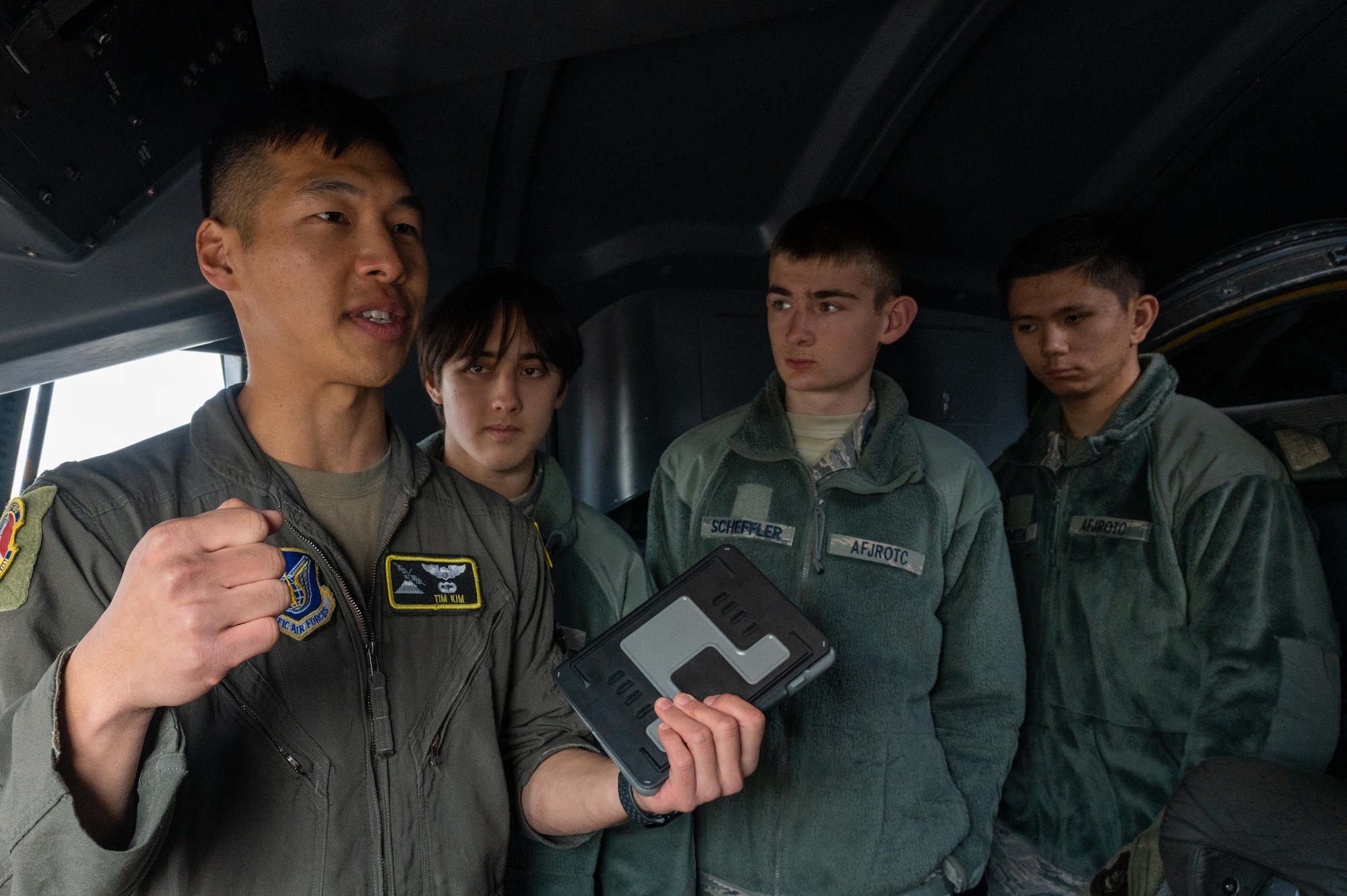 A U.S. Air Force pilot speaks with Yokota High School students in a C-130J Super Hercules aircraft