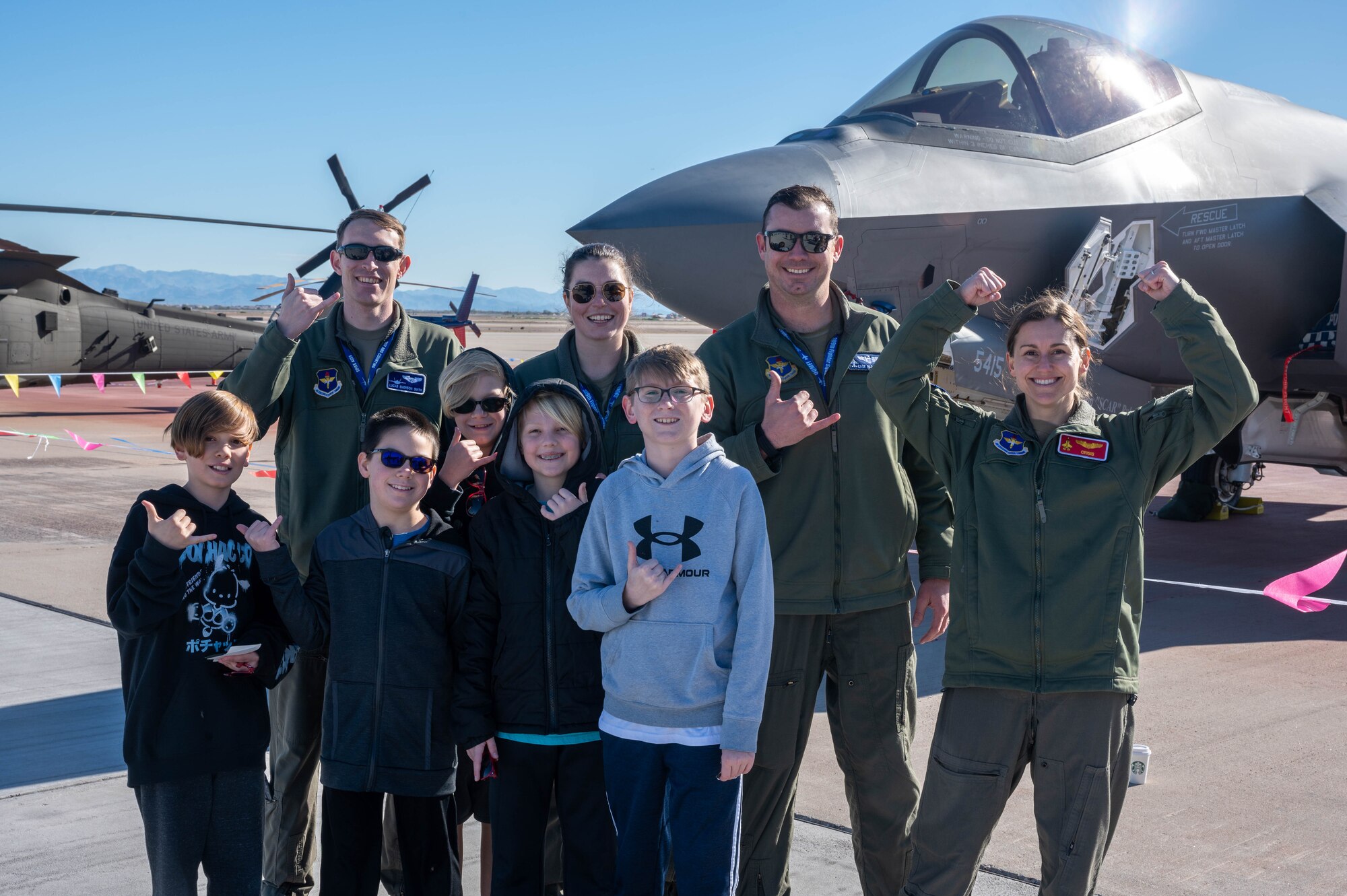 Airmen from the 56th Fighter Wing, assigned to Luke Air Force Base, Arizona, and elementary school students pose in front of an F-35 Lightning II aircraft at the Mesa Gateway Aviation Day, Jan. 24, 2023, in Mesa, Arizona.