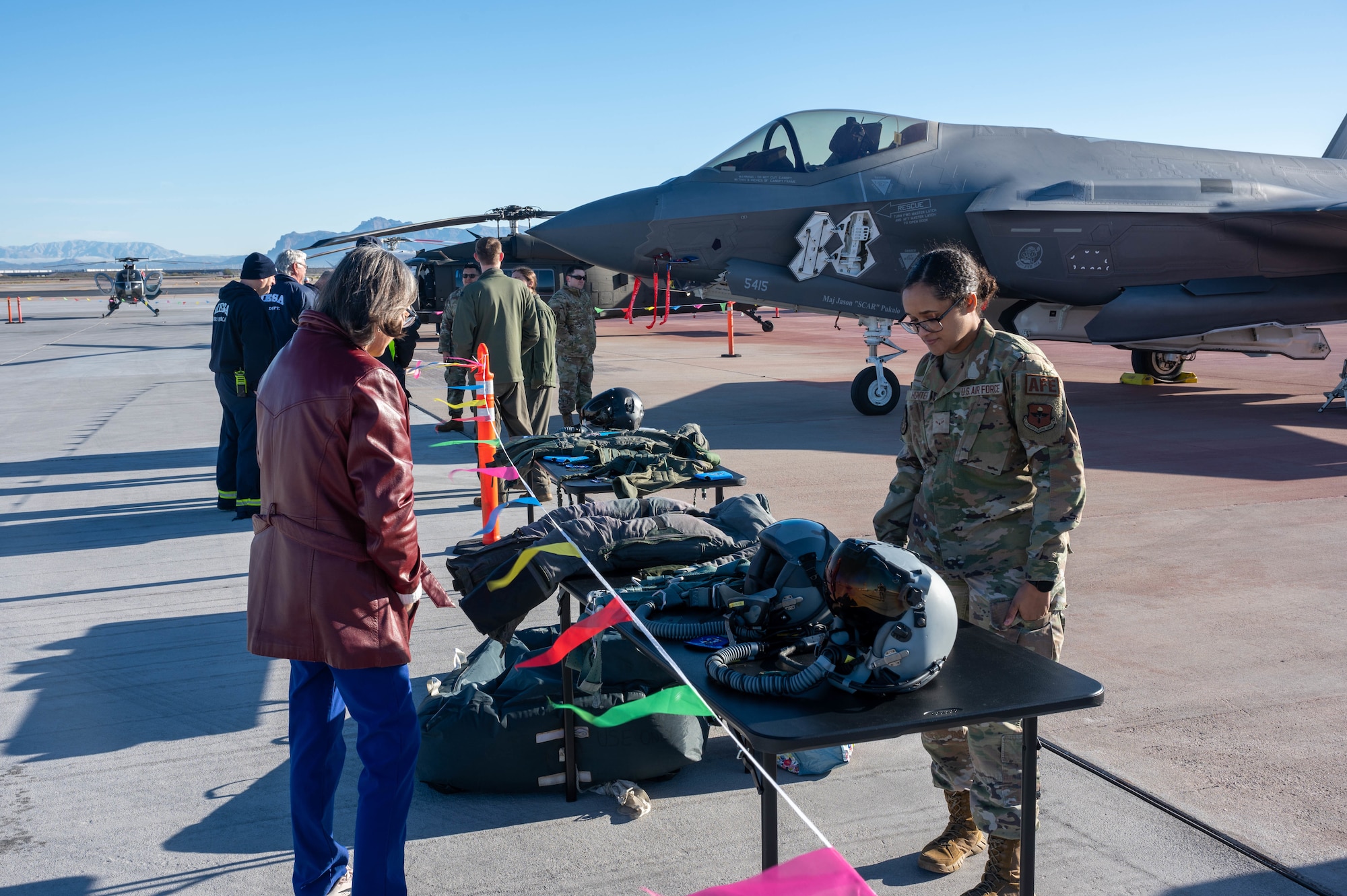 U.S. Air Force Airman 1st Class Alex Hunter, 56th Operational Support Squadron aircrew flight equipment technician, assigned to Luke Air Force Base, Arizona, showcases pilot flight equipment at the Mesa Gateway Aviation Day, Jan. 24, 2023, in Mesa, Arizona.