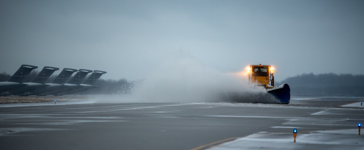 A heavy-equipment operator from the 88th Civil Engineer Group’s snow-removal team uses a plow to clear the runway at Wright-Patterson Air Force Base, Ohio, Jan. 25, 2023. The team is responsible for clearing more than 18 million square feet of concrete to keep the airfield open. (U.S. Air Force photo by Matthew Clouse)