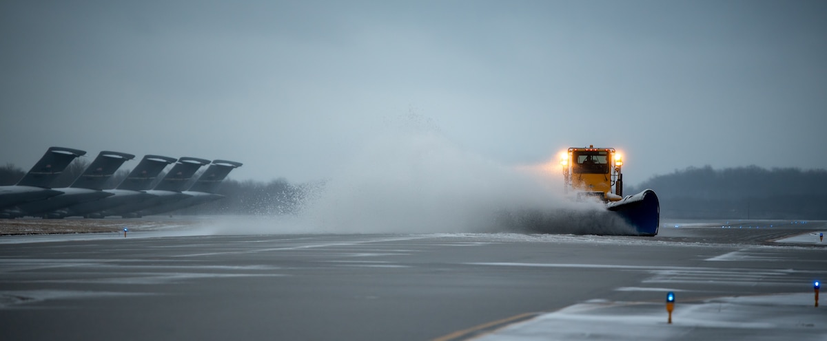 A heavy-equipment operator from the 88th Civil Engineer Group’s snow-removal team uses a plow to clear the runway at Wright-Patterson Air Force Base, Ohio, Jan. 25, 2023. The team is responsible for clearing more than 18 million square feet of concrete to keep the airfield open. (U.S. Air Force photo by Matthew Clouse)
