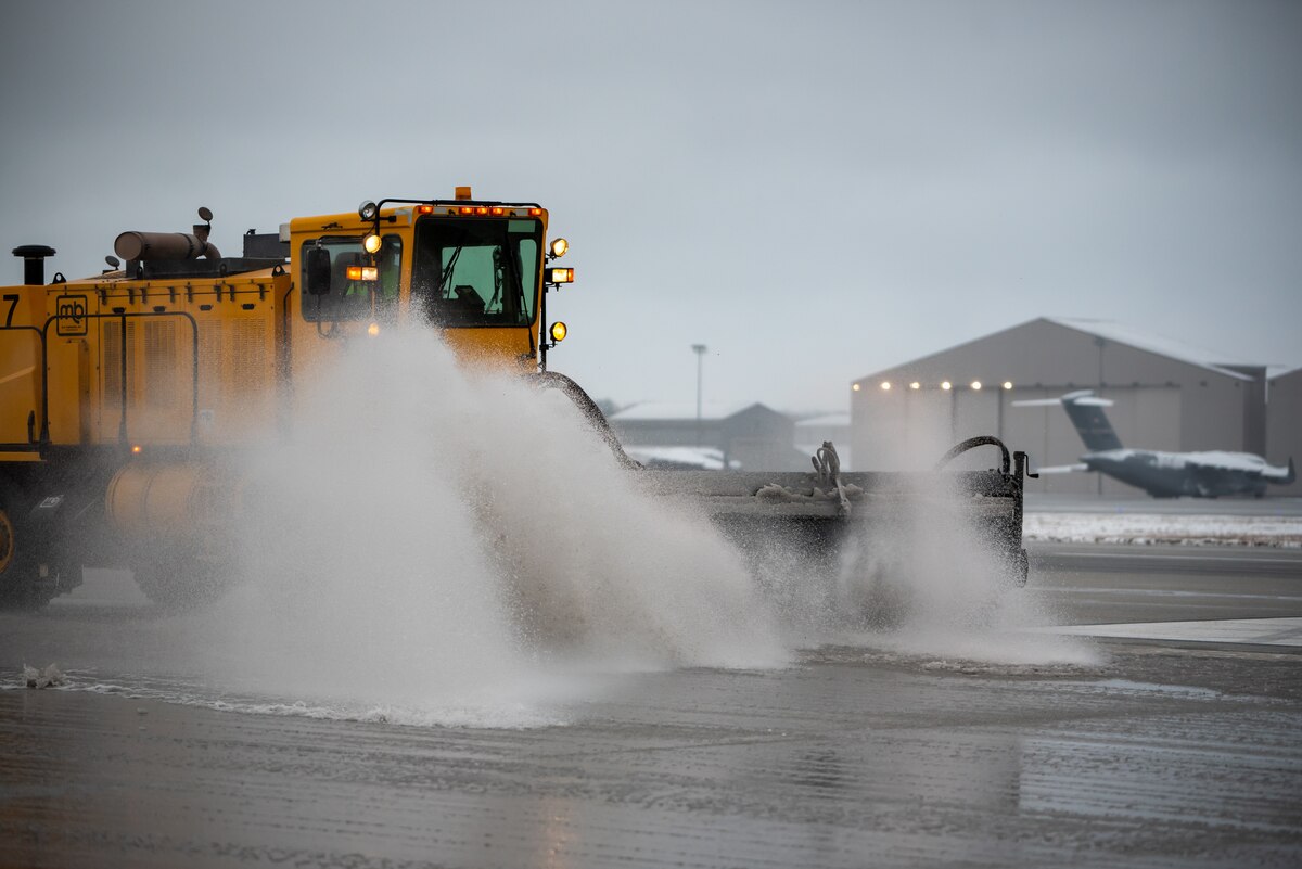 A heavy-equipment operator from the 88th Civil Engineer Group’s snow-removal team uses a brush to clear the runway at Wright-Patterson Air Force Base, Ohio, Jan. 25, 2023. The team is responsible for clearing more than 18 million square feet of concrete to keep the airfield open. (U.S. Air Force photo by Matthew Clouse)