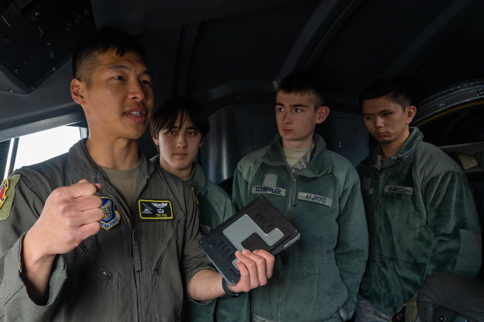 A U.S. Air Force pilot speaks with Yokota High School students in a C-130J Super Hercules aircraft