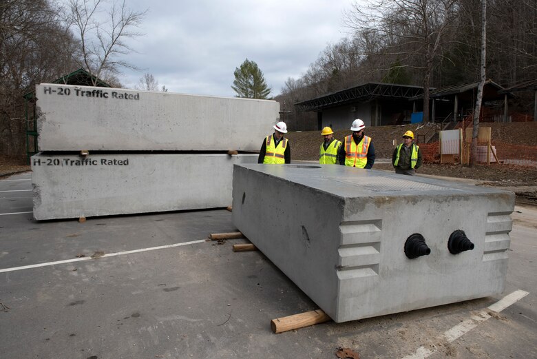 U.S. Army Corps of Engineers Nashville District and National Park Service officials look at a new septic system Jan. 20, 2023, prior to its installation. Construction for a wastewater project is underway to provide a sanitary upgrade for the National Park Service Blue Heron Mine at the Big South Fork National River and Recreation Area in Stearns, Kentucky. (USACE Photo by Lee Roberts)