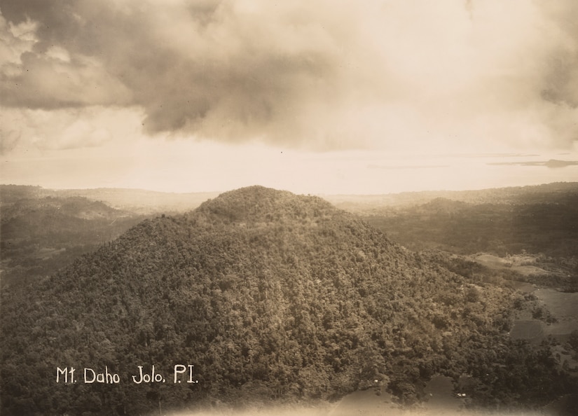 An aerial view of a forested mountain.