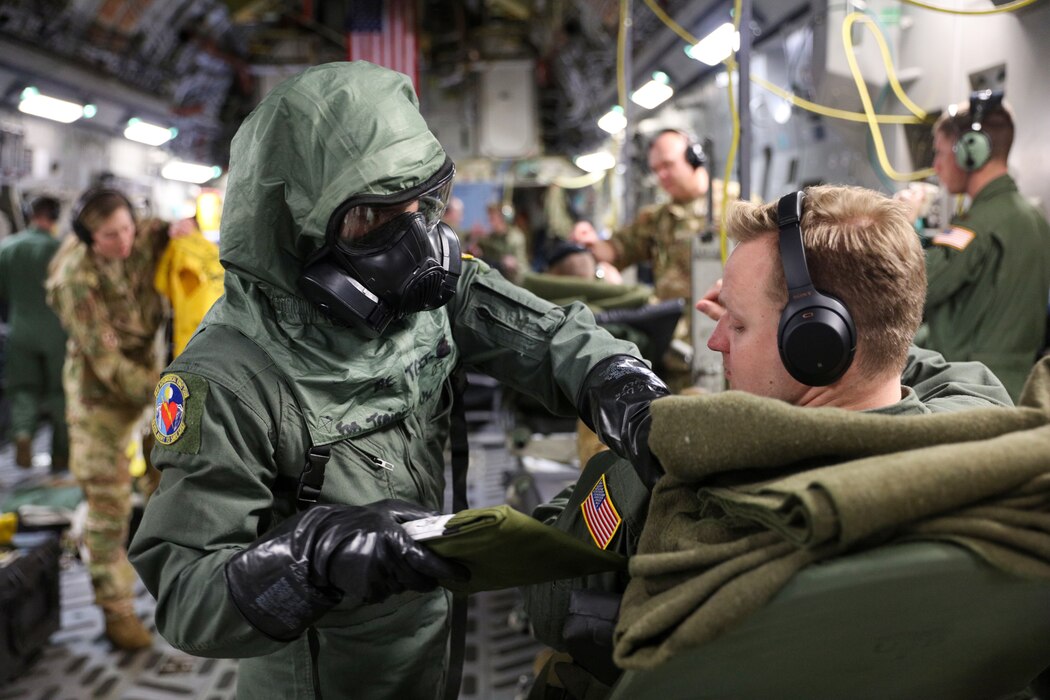 Image of an Airman training with a patient on an aircraft.