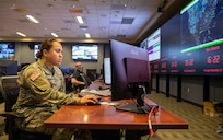 U.S. Army Staff Sgt. Josephine Danielson, assigned to Joint Task Force Civil Support, sits at her assigned position in a newly-renovated joint operations center at JTF-CS headquarters on Fort Eustis, Virginia, Nov. 28, 2022.