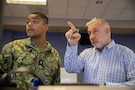 U.S. Navy Operations Specialist 2nd Class Jarel Picquet, and Mike Balser, both assigned to Joint Task Force Civil Support, review the seating chart in a newly-renovated joint operations center at JTF-CS headquarters on Fort Eustis, Virginia, Nov. 28, 2022.