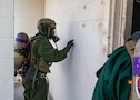 Lance Cpl. Justin Wojtyslak, a member of the hazardous materials response team assigned to the Marine Corps Chemical, Biological Incident Response Force, marks a building before entering to check for notional toxic industrial chemical contamination during Exercise Sudden Response 23 at Fort Hood, Texas Dec. 9, 2022.