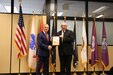 Steven G. Batts holds assumption of charter while shaking hands with Darryl J. Colvin