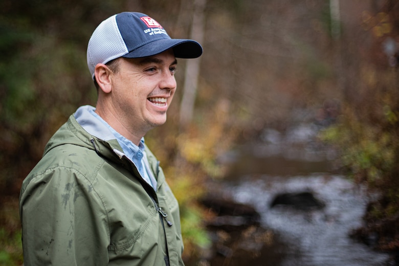 Taylor Bell, a regulator from the U.S. Army Corps of Engineers (USACE) New England District stands along a river in Vermont while field testing an interim OHWM identification data sheet.