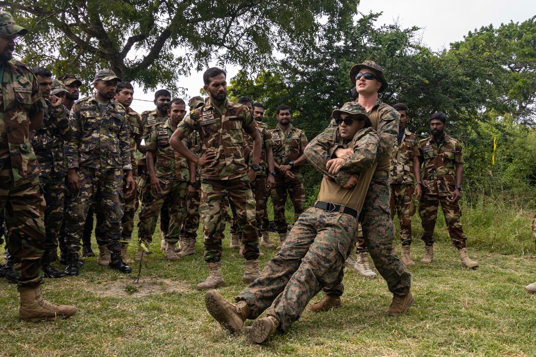 U.S. Navy hospital corpsman demonstrate a buddy drag during a Tactical Combat Casualty Care class with Sri Lanka navy sailors and marines in in Mullikulam, Sri Lanka.
