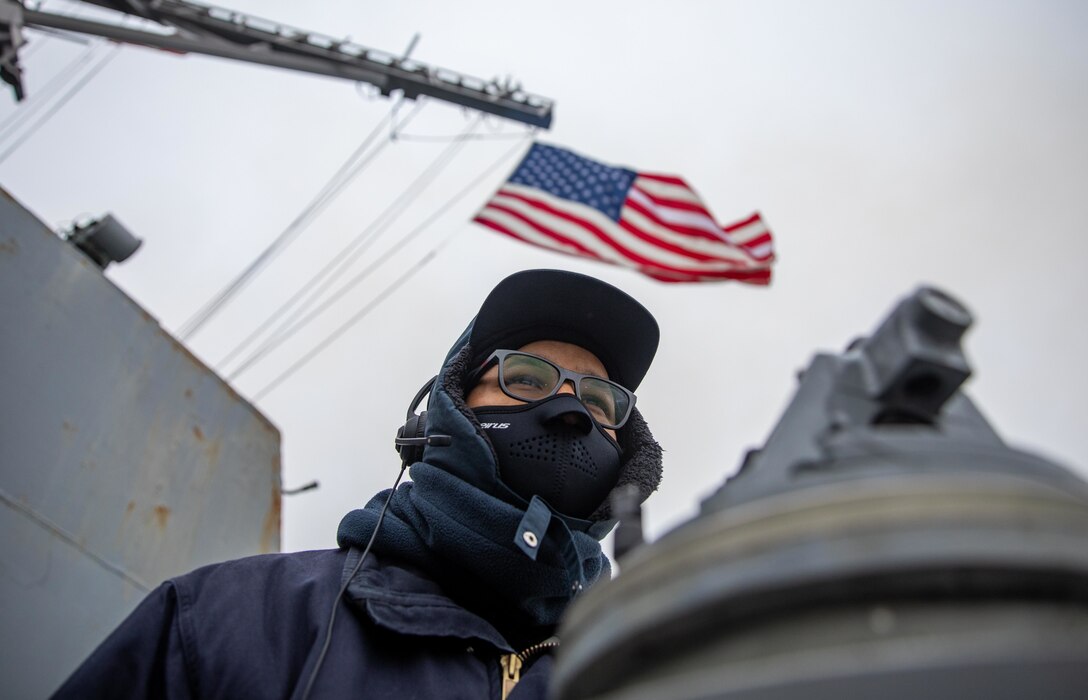 Quartermaster 2nd Class Zachary Quidachay stands watch aboard USS Roosevelt (DDG 80) as the ship arrives in Klaipda, Lithuania.