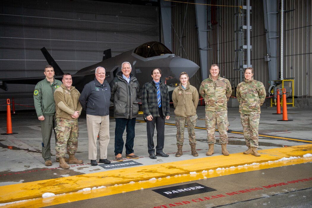 Photo of Vermont’s Lt. Gov. David Zuckerman (center) standing for a picture with (from left to right) Col. Michael Blair, 158th Fighter Wing operations group commander, Tech. Sgt. Alexander Benckert, avionics technician with the 158th Fighter Wing maintenance group, Mr. Jack Russell, 158th Fighter Wing honorary commander, Mr. Ernie Pomerleau, 158th Fighter Wing honorary commander, Staff Sgt. Isabel Murphy, crew chief with the 158th Fighter Wing maintenance group, Col. Daniel Finnegan, commander of the 158th Fighter Wing, and Chief Master Sgt. Adrianne Schulz, command chief for the 158th Fighter Wing, in front of an F-35A Lightning II aircraft at the Vermont Air National Guard Base, South Burlington, Vermont, Jan. 26, 2023.
